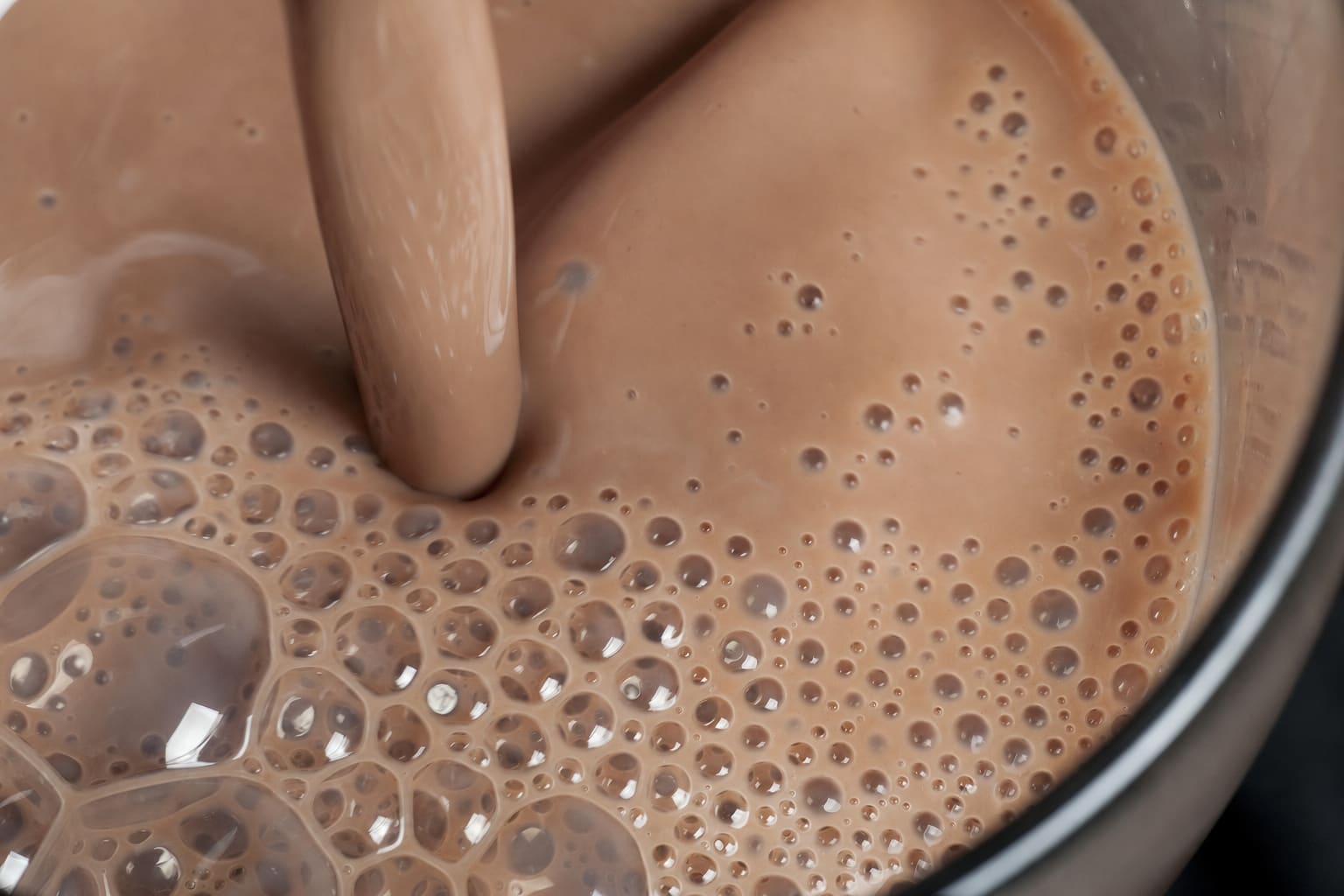 Fresh chocolate milk being mixed until smooth and frothy